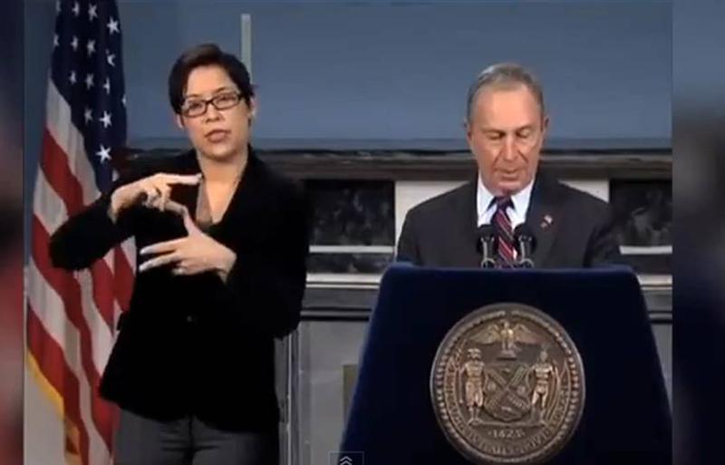 Lydia Callis doing ASL interpretation during a Mayor Bloomberg Sandy briefing.