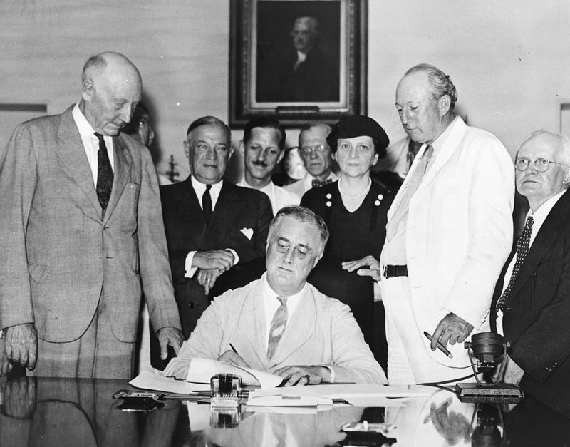 President Franklin Delano Roosevelt signs the Social Security Act on August 14, 1935