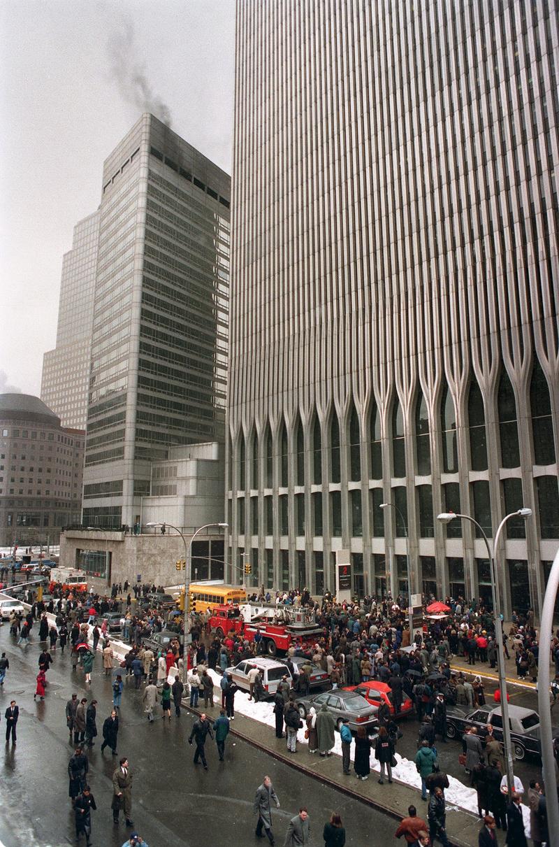 Firefighters and rescue crews work outside the WTC after smoke swept through the 110-story building after the ceiling of a train station collapsed 26 February 1993.