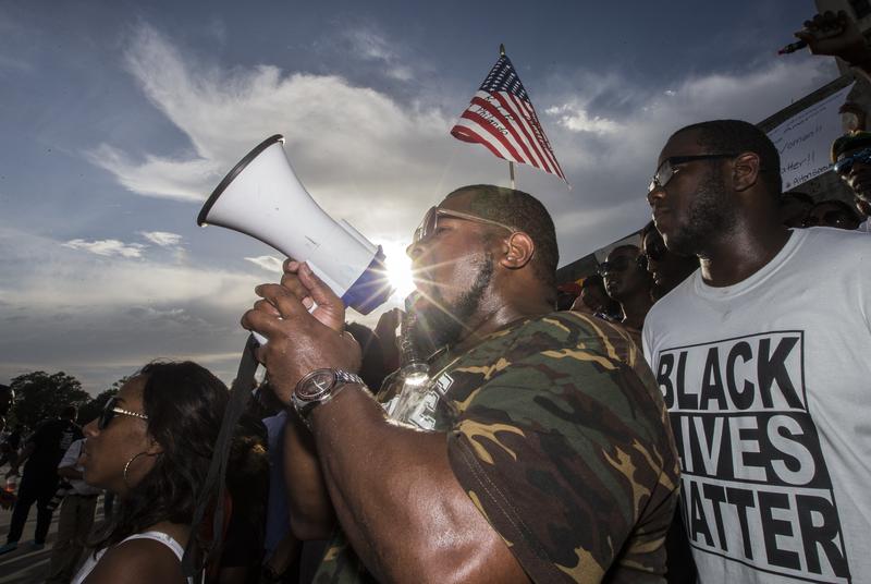 Demonstrators gather after marching at the Louisiana Capitol to protest the shooting of Alton Sterling on July 9, 2016 in Baton Rouge, Louisiana.