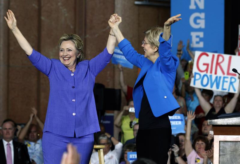 Democratic Presidential candidate Hillary Clinton (L) and U.S. Sen Elizabeth Warren (D-MA) (R) wave to the crowd before a campaign rally in Cincinnati, Ohio on June 27, 2016.