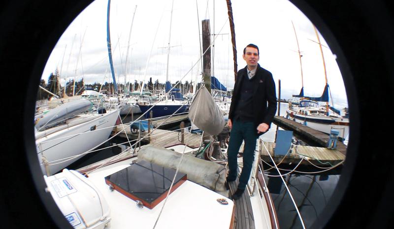Musician and composer Jherek Bischoff stands on the boat he grew up on near Seattle, Wash.