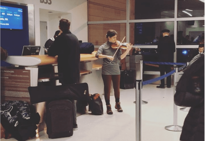 Violinist Michelle Ross plays while her flight is delayed at JFK.