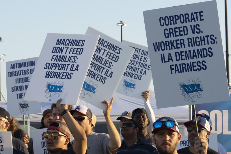 Longshoremen carry signs and chant Tuesday, Oct. 1, 2024, outside the Bayport Container Terminal in Seabrook.