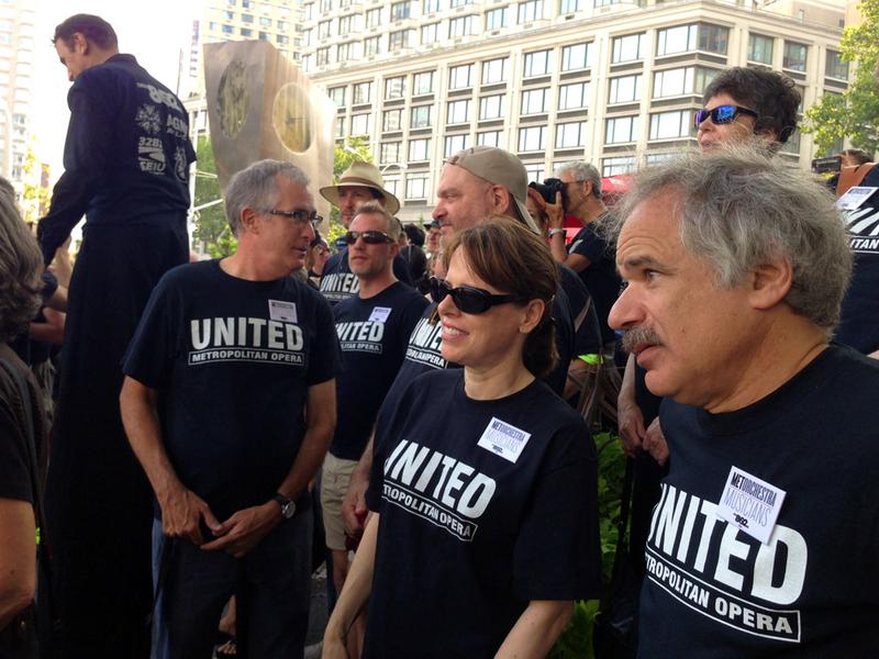 Members of the American Guild of Musical Artists and the American Federation of Musicians, two of the unions embroiled in contract negotiations with Metropolitan Opera management, rally this morning at Dante Park across from Lincoln Center.