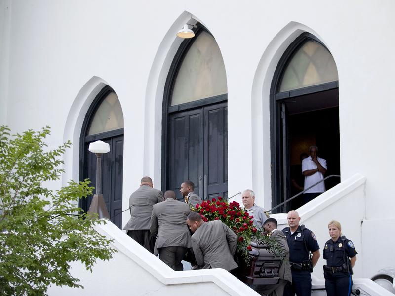 Pallbearers carry the casket of Sen. Clementa Pinckney, one of the nine killed in last week's shooting, into Emanuel AME Church in Charleston, S.C., for his wake Thursday.