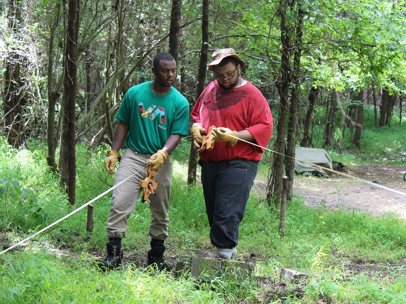 Kalen Gilliam (left) and Justis Jackson take measurements at the Urban Archaeology Corps excavation site about 10 miles outside of Richmond, Va.