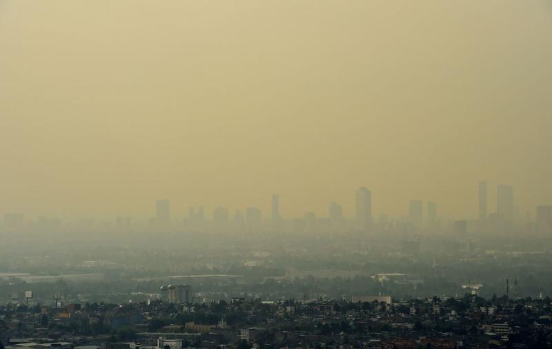 View from Tlanepantla of Mexico City blanketed by smog on March 18, 2016. Mexican officials lifted a four-day air pollution alert in the nation's densely-populated capital after ozone levels dropped, according to them, to acceptable levels. Mexico City authorities issued the first air pollution alert in 14 years due to high ozone levels, restricting traffic, encouraging children to stay indoors and ordering factories to cut emissions. (Ronaldo Schemidt/AFP/Getty Images)