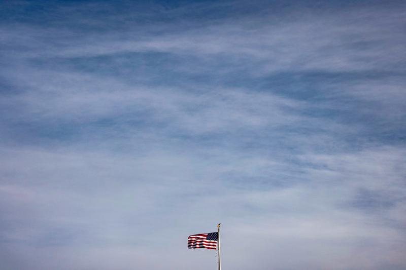 The American flag flies above the White House in Washington, DC.