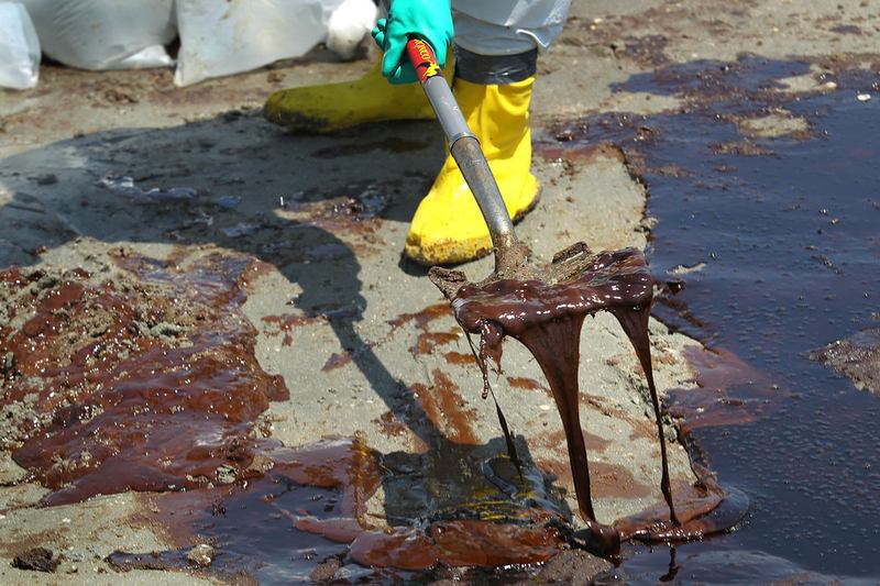  A BP cleanup crew shovels oil from a beach on May 24, 2010 at Port Fourchon, Louisiana. BP CEO Tony Hayward, who visited the beach, said that BP is doing everything possible to clean up the spill.