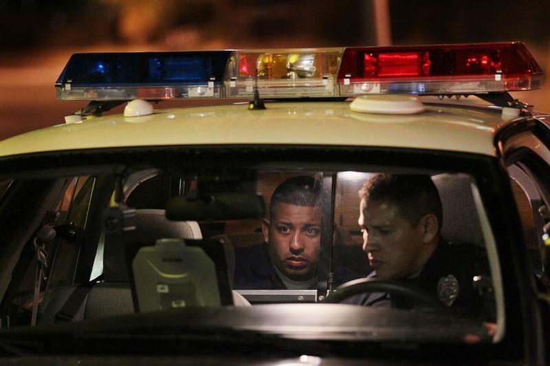 Tucson Police officer Luis Hernandez questions a suspect following a fight June 3, 2010 in Tucson, Arizona. Tucson is gearing up to begin training its officers on the implementation of SB 1070.