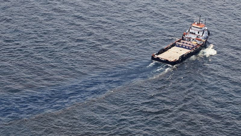A ship passes through oil covered water near the site of the Deepwater Horizon oil spill on June 19, 2010 in the Gulf of Mexico off the coast of Louisiana. 