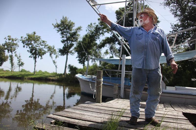 Shrimper Laveau Trudeau, Jr. stands next to his trawler in Plaquemines Parish July 13, 2010 in Wood Park, Louisiana. Trudeau has not been able to shrimp this year due to the BP oil spill.