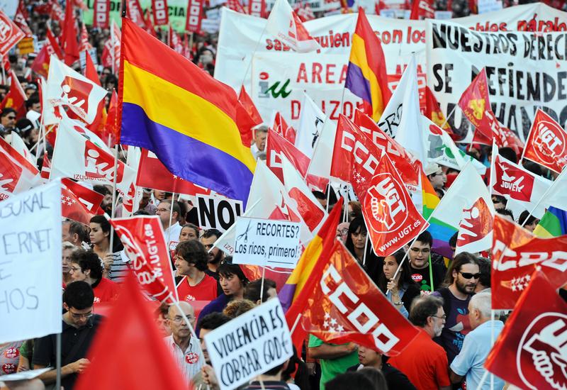 Protesters walk with banners and flags as they demonstrate at the end of a nationwide general strike day on September 29, 2010 in Madrid, Spain. 