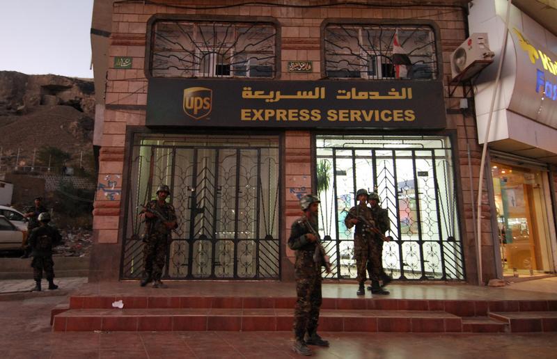 Yemeni security are seen outside a branch of the US package delivery firm UPS in Sanaa on October 30, 2010. Yemen launched a probe after explosives were found in air parcels sent to US synagogues.