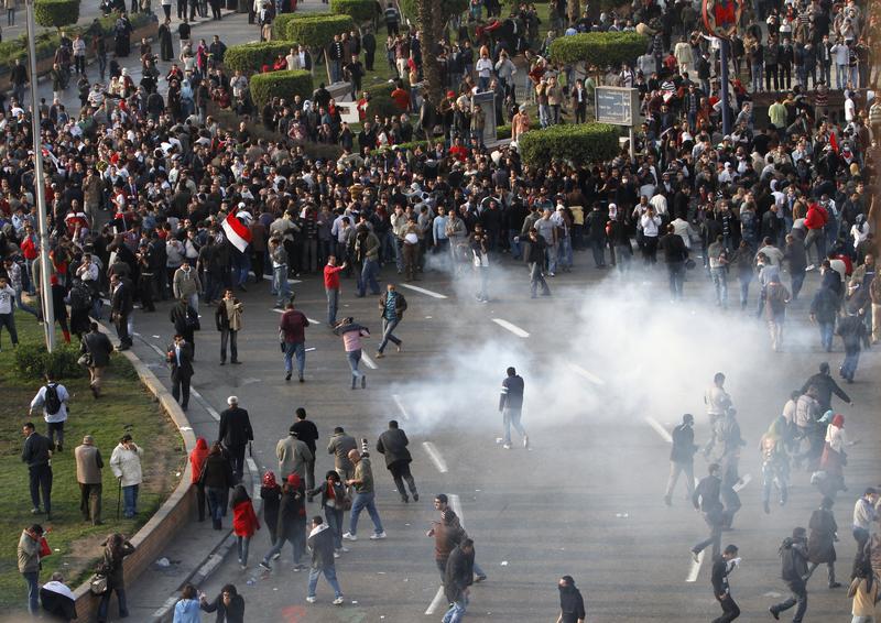 Egyptian demonstrators protest in central Cairo amidst tear gas fire by Egyptian police to demand the ouster of President Hosni Mubarak and calling for reforms on January 25, 2011. 