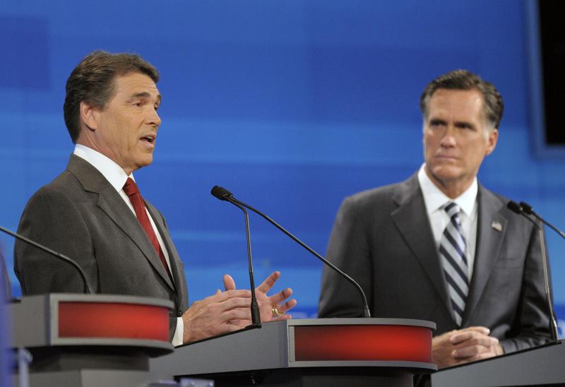 Republican presidential candidates, Texas Gov. Rick Perry (L) speaks as former Massachusetts Gov. Mitt Romney listens in the Fox News/Google GOP Debate on September 22, 2011 in Orlando, Florida. 