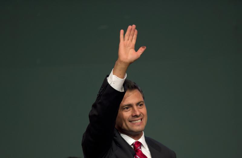 Mexican President Enrique Peña Nieto celebrates after learning the first official results of his election.
