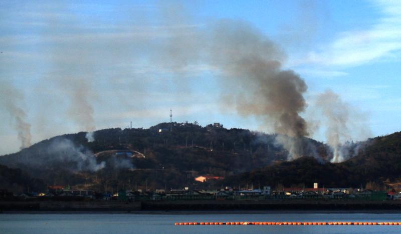 This picture taken on November 23, 2010 by a South Korean tourist shows huge plumes of smoke rising from Yeonpyeong island in the disputed waters of the Yellow Sea on November 23, 2010.