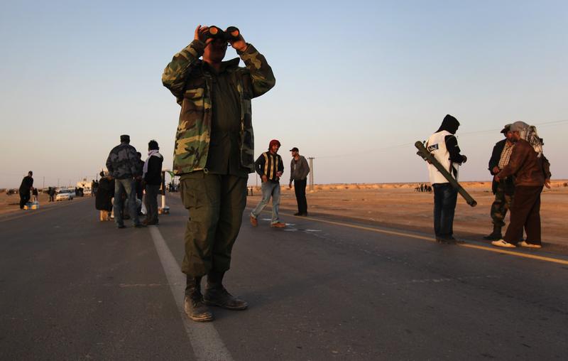 A rebel fighter scans the horizon for government troops on March 3, 2011 in Ajdabiya, Libya.