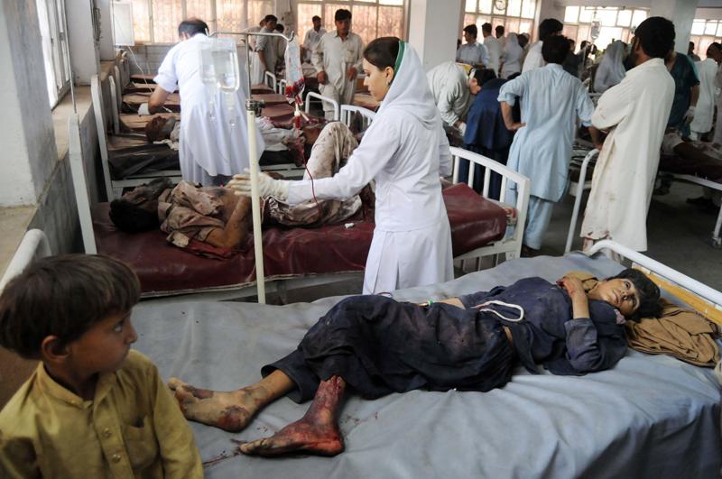 Pakistani paramedics treat injured Mohmand blast victims at a hospital in Peshawar.