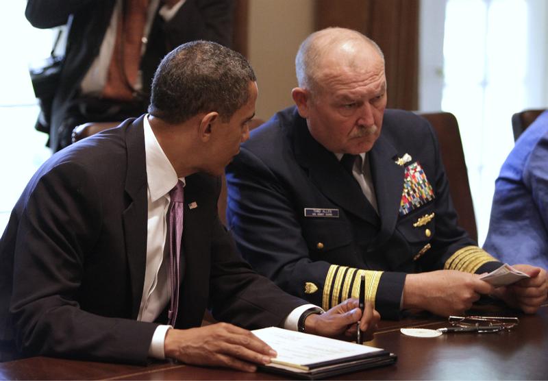 U.S. President Barack Obama talks to retired Coast Guard Admiral Thad Allen, National Incident Commander, during a meeting with cabinet members to discuss the administration's response to oil spill.