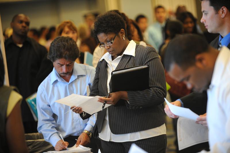 Job seekers look for employment at a job fair in Los Angeles on September 20, 2010