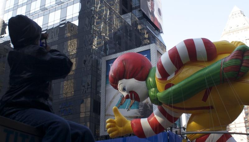 One kid gets a great view of the Ronald McDonald Balloon at Macy's Annual Thanksgiving Day parade.