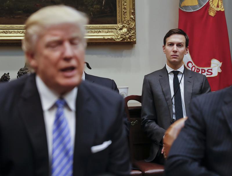 White House Senior Adviser Jared Kushner listens at right as President Donald Trump speaks during a breakfast with business leaders in the Roosevelt Room of the White House in Washington.