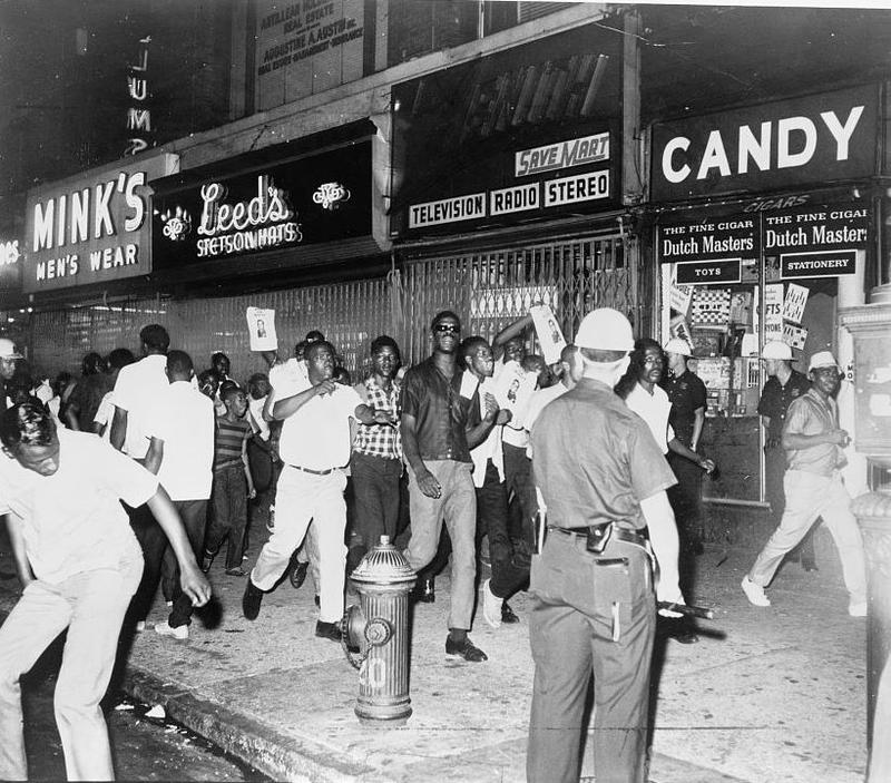 During the Harlem Riots of 1964, protesters march down 125th street with photographs of Lieutenant Thomas Gilligan.