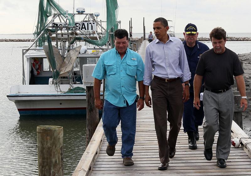 U.S. President Barack Obama is greeted by Mayor David Camardelle (R) of Grand Isle and Chris Camardelle (L) in Grand Isle, Louisiana, during his third visit to the state, June 4, 2010