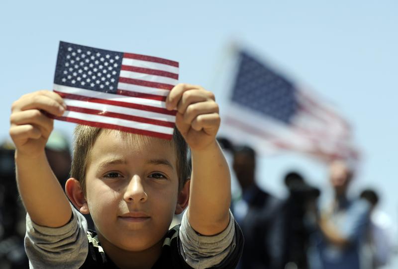 A boys shows a US flag as President Barack Obama speaks on immigration at the Chamizal National Memorial on May 10, 2011 in El Paso, Texas. 