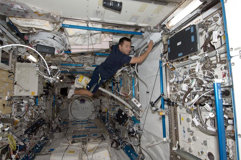 Japan Aerospace Exploration Agency astronaut Aki Hoshide, uses a vacuum cleaner during housekeeping operations in the Kibo laboratory of the International Space Station  July 28, 2012 in Space.