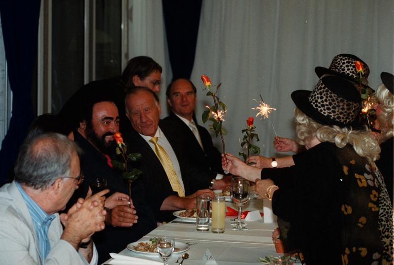 Impresario Tibor Rudas sits to the left of Luciano Pavarotti in 2000