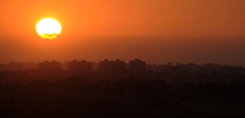 A picture taken at sunset on August 10, 2014 shows buildings in the northern Gaza Strip from the Israeli side of the Israel-Gaza Border.