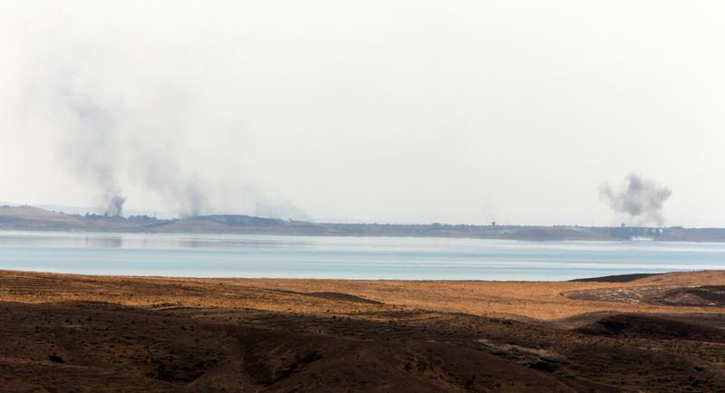 Smoke rises in the horizon following US airstrikes targeting Islamic State (IS) militants at Mosul Dam on the outskirts of the northern city of Mosul where insurgents are fighting Kurdish forces on Au