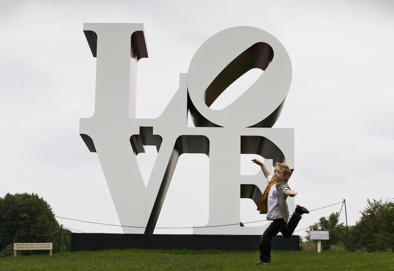 A young boy plays in front of sculpture entitled 'The American Love' by Robert Indiana in the gardens of Chatsworth House near Bakewell, Derbyshire on September 14, 2008.