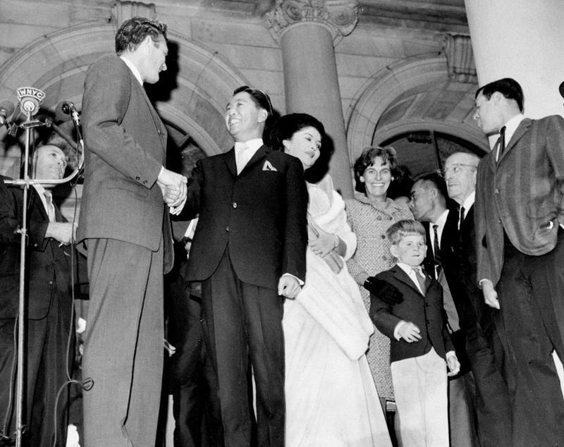 Mayor John Lindsay (left) shakes hands with Philippine President Ferdinand E. Marcos at ceremony, as Mrs. Marcos, Mrs. Lindsay and son John Lindsay Jr. look on, September 21, 1966.