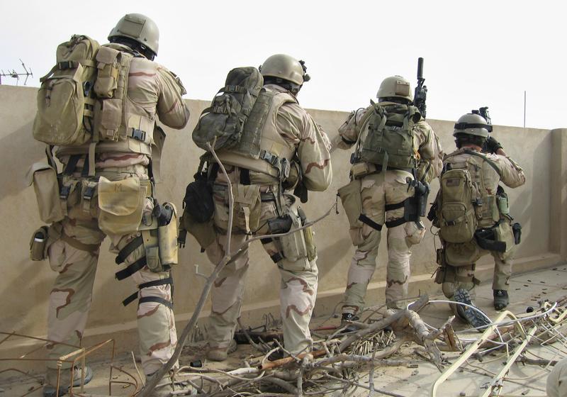 A team of U.S. Navy SEALs fires on insurgents from a rooftop Friday, April 21, 2006 in Ramadi 115 km (70 miles) west of Baghdad, Iraq.