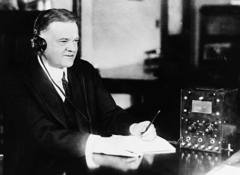 U.S. Secretary of Commerce Herbert Hoover listens to the radio broadcast in March 11, 1922 of "Air News".