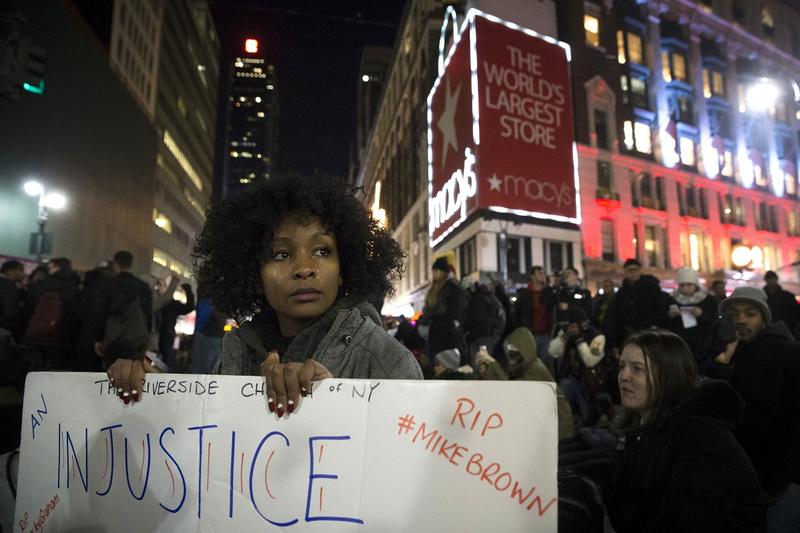 Protestor Rayyan Ali cries as her protest group occupies Herald Square Dec. 4, 2014, in New York responding to a grand jury's decision not to indict the police officer involved in Eric Garner's death.