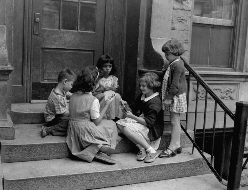 This group of Manhattan youngsters are shown playing their version of "Old Maid", with a deck of cards on the steps on 52nd Street between Ninth and Tenth Avenues, September 8, 1950.