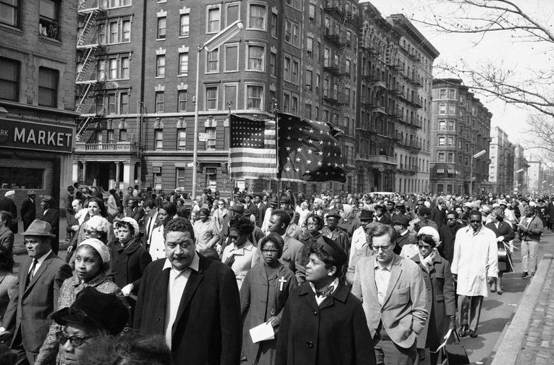 Mourners parade down Seventh Avenue near 112th Street in New York City's Harlem section, April 7, 1968, on way to the memorial service for Dr. Martin Luther King, Jr. in Central Park.
