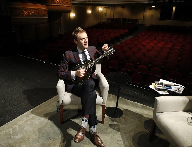 Chris Thile tunes his mandolin on the stage of the Fitzgerald Theater in St. Paul, Minn., Tuesday, April 5, 2016. 