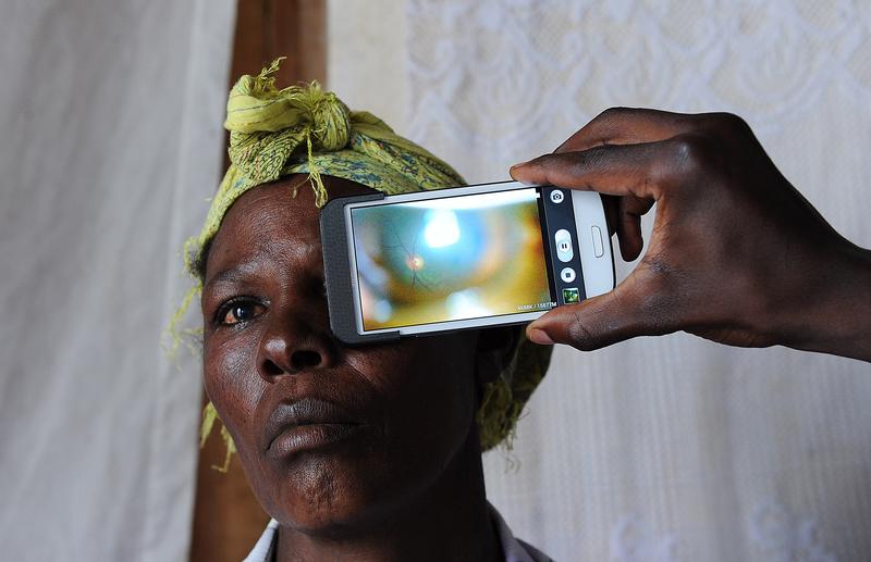 August 28, 2013: in Kianjokoma village, near Kenya's lakeside town of Naivasha, a technician scans the eye of a woman with a smartphone application. 