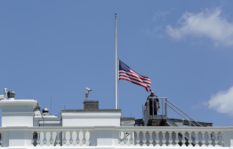 Personnel leave after lowering the US flag to half-staff at the the White House in Washington following President Obama's statement on the mass shooting at an Orlando nightclub. 
