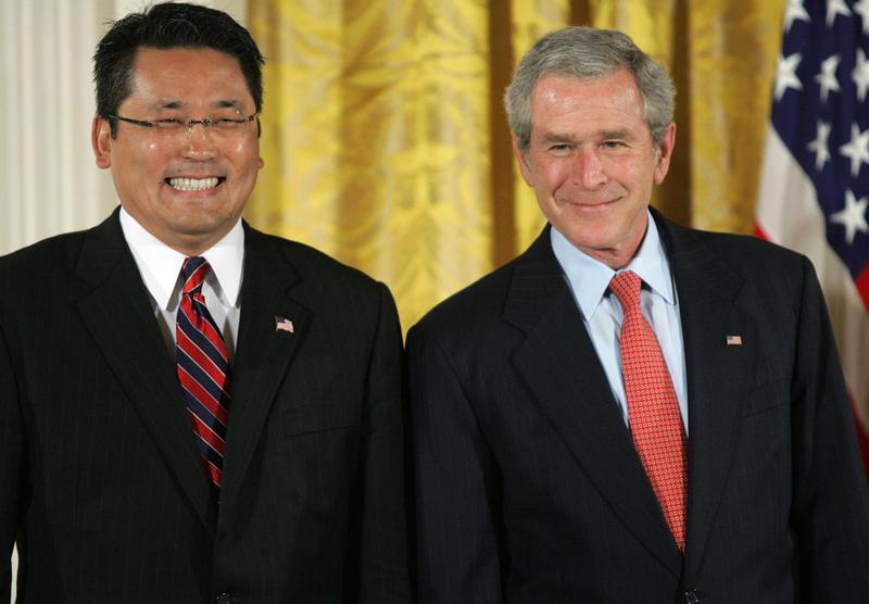 President George W. Bush smiles alongside Kay Hiramine, CEO of Private Sector Consulting in Colorado Springs, Colorado.