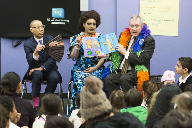 Drag queen Angel Elektra, flanked by Queens Library president Dennis Walcott (holding fan) and Council Member Danny Dromm