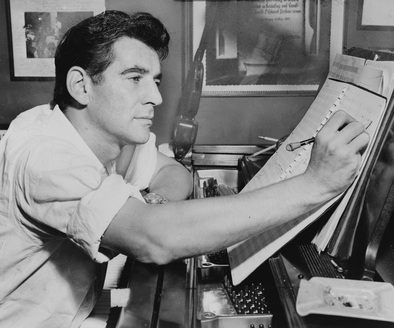 Leonard Bernstein seated at the piano in 1955.