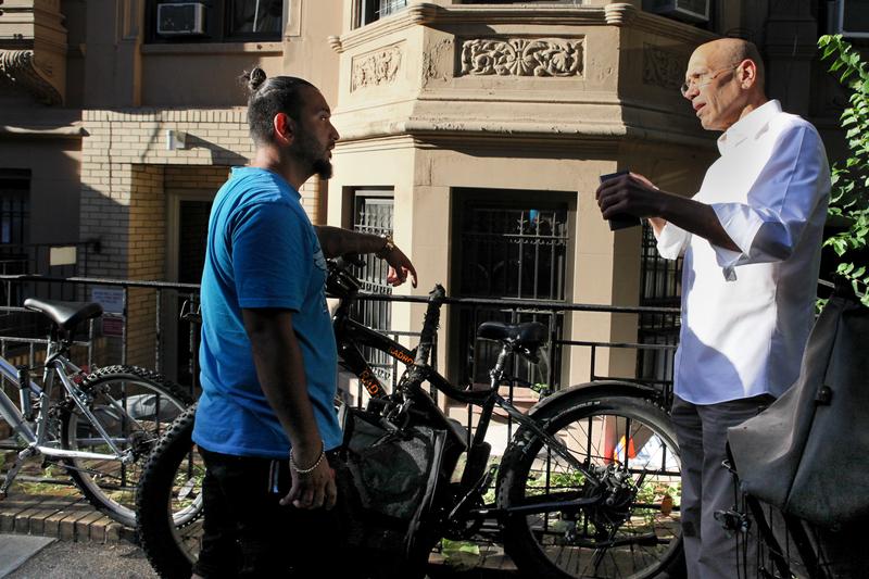 Matthew Shefler and biker Jonathan Lyons discussing the legality of electric bikes. Lyons insists he's a careful rider, but Shefler points out this type of electric bike, with a throttle, is illegal.